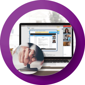 A man smiling looking at his laptop.